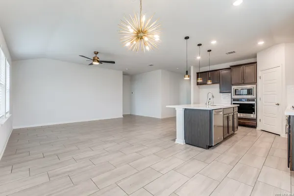 a view of kitchen with stainless steel appliances a refrigerator sink and microwave