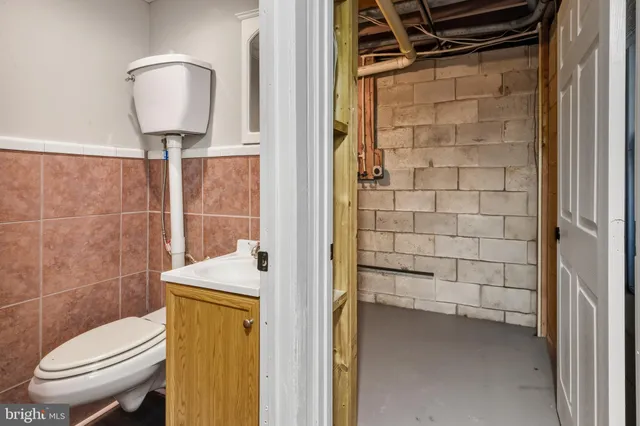a bathroom with a toilet a sink and shower