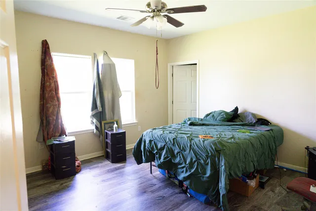 a bed sitting in a bedroom next to a window