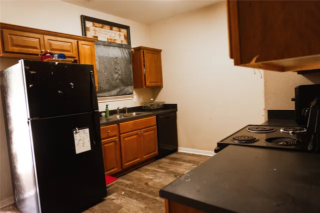 a kitchen with stainless steel appliances granite countertop a refrigerator and a stove