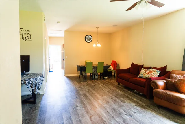 a living room with furniture and a wooden floor