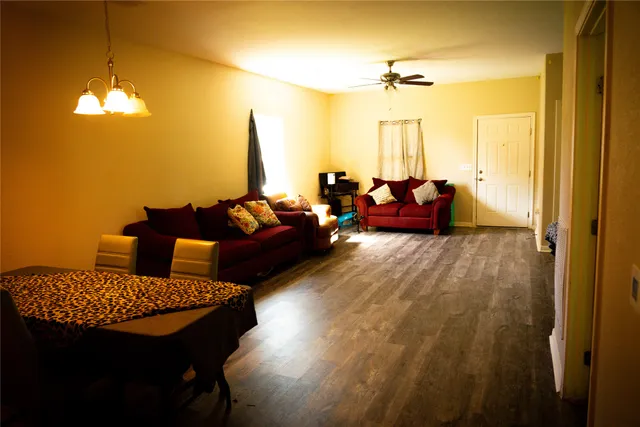 a living room with furniture and a chandelier