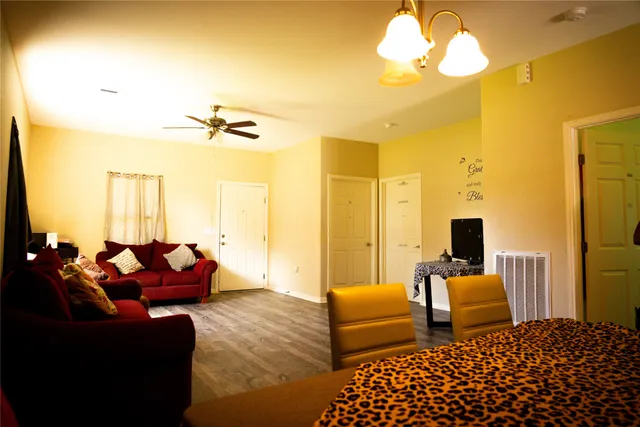 a bedroom with furniture and a flat screen tv