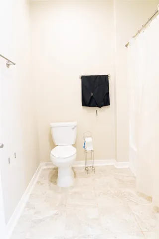 a living room with a toilet and a flat screen tv