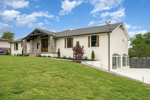 a front view of house with yard and green space