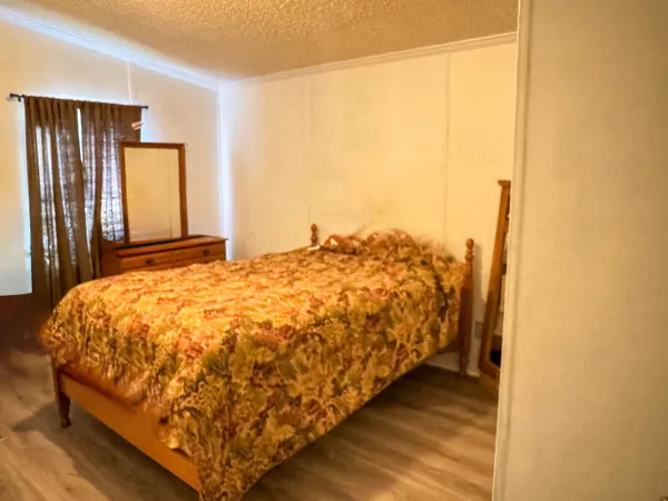 a bed sitting in a bedroom next to a window