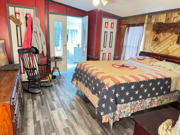 a bed sitting in a bedroom next to a window