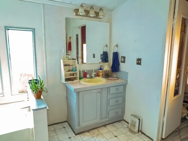 a bathroom with a sink vanity and a mirror