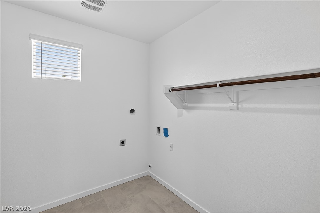 347 Sam Way Mesquite, NV 89027 - Photo 29 of 32 A dedicated laundry room with hookups and a convenient clothing rod for seamless utility.