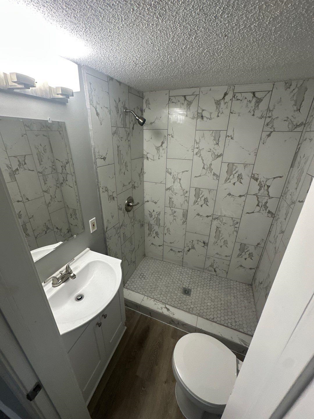 693 Granada Road Memphis, TN 38109 - Photo 4 of 7 a bathroom with a sink toilet and shower