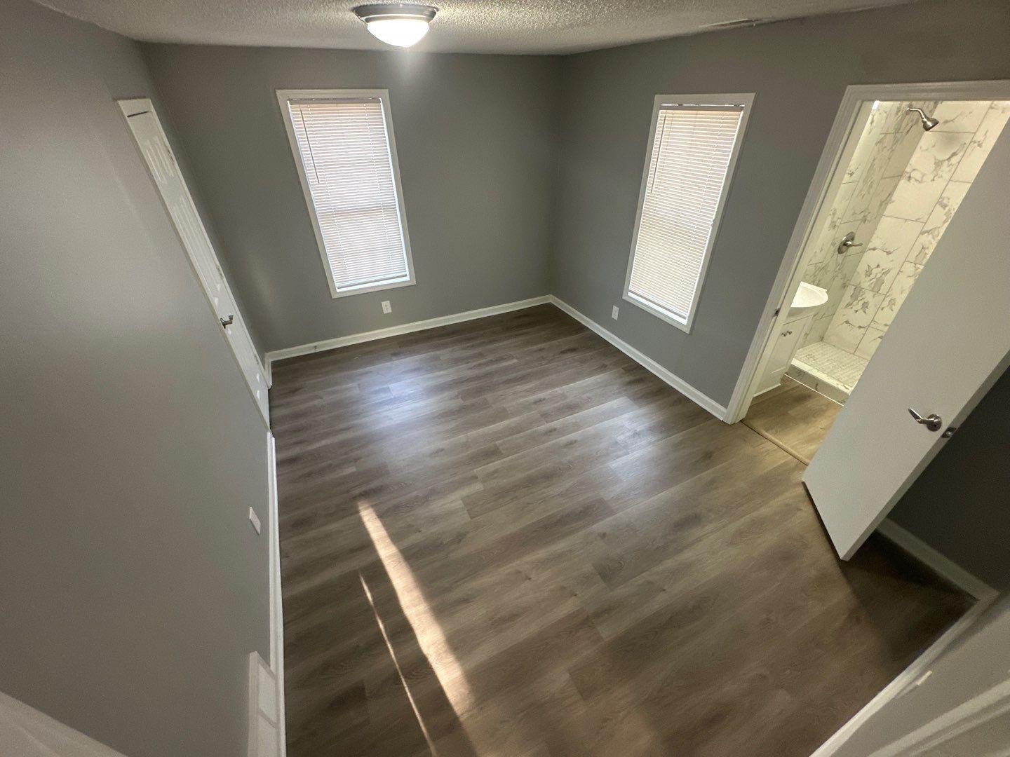 693 Granada Road Memphis, TN 38109 - Photo 5 of 7 an empty room with wooden floor and windows