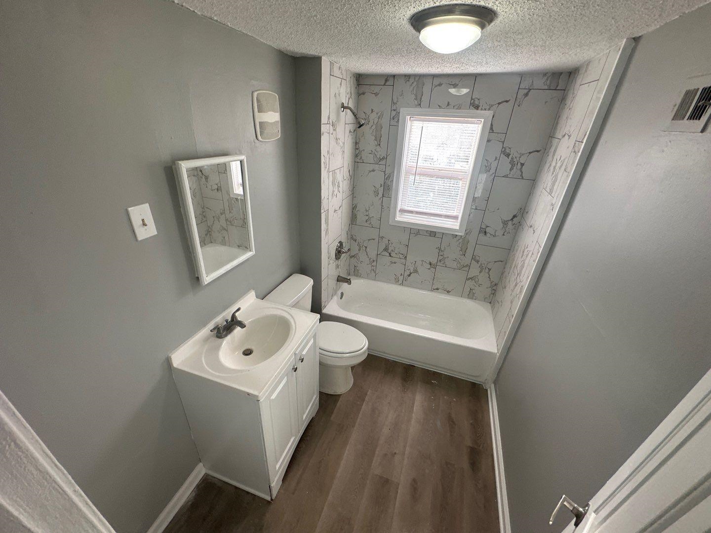 693 Granada Road Memphis, TN 38109 - Photo 7 of 7 a bathroom with a sink toilet and shower