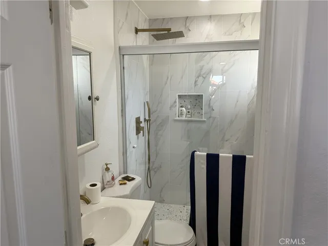 a bathroom with a sink toilet and shower