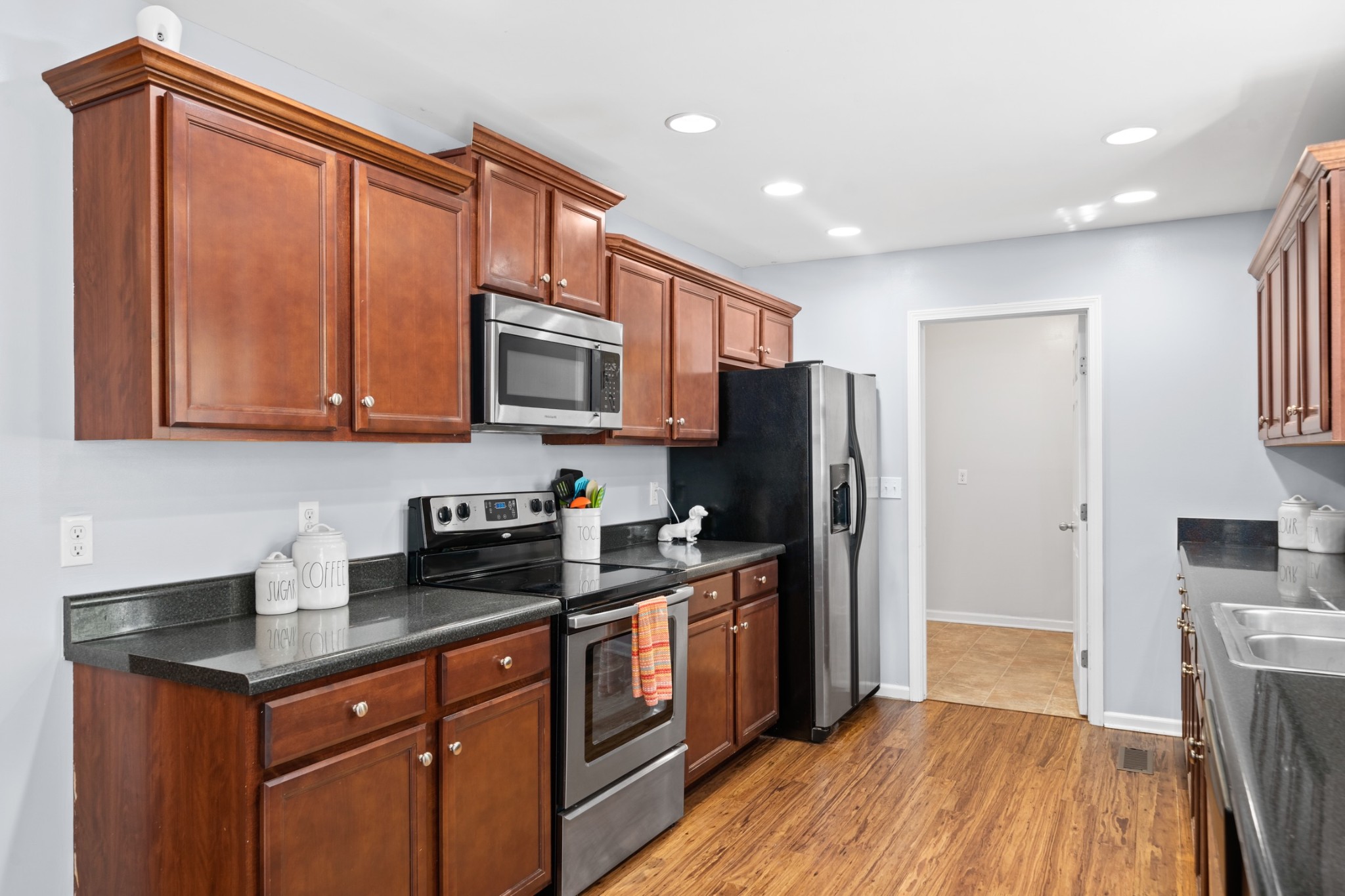 4439 Taylor Road Springfield, TN 37172 - Photo 13 of 29 a kitchen with stainless steel appliances granite countertop a refrigerator a sink dishwasher a stove with wooden cabinets and floor