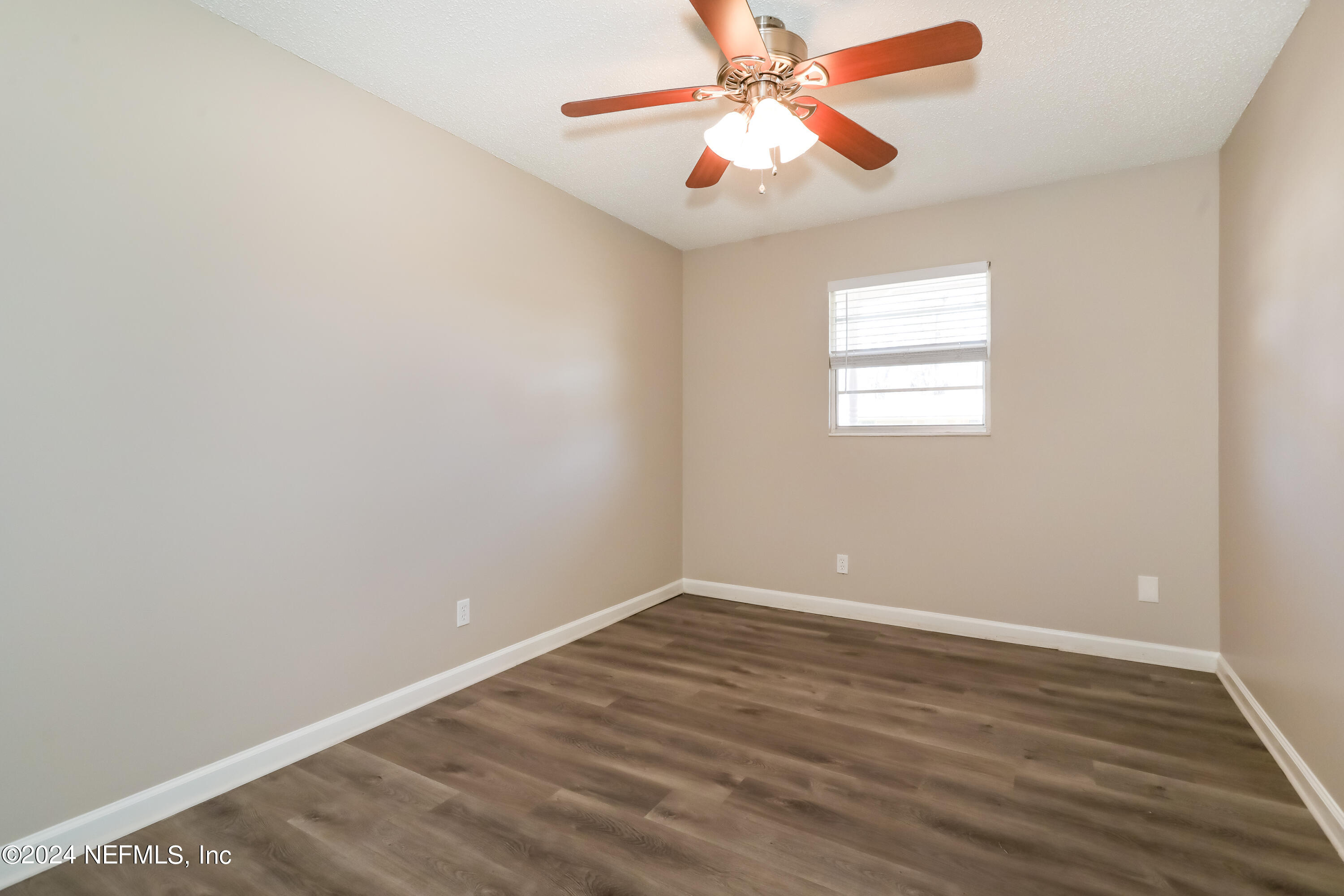 1220 Arbor Circle Orange Park, FL 32073 - Photo 11 of 15 an empty room with wooden floor fan and windows