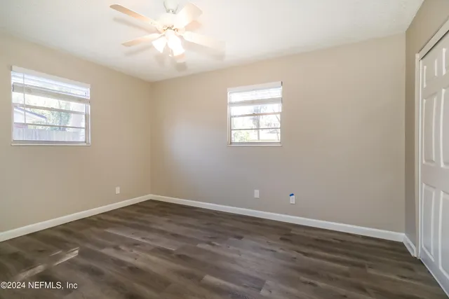 wooden floor in an empty room with a window