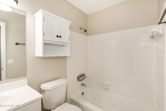 a bathroom with a toilet and a bathtub