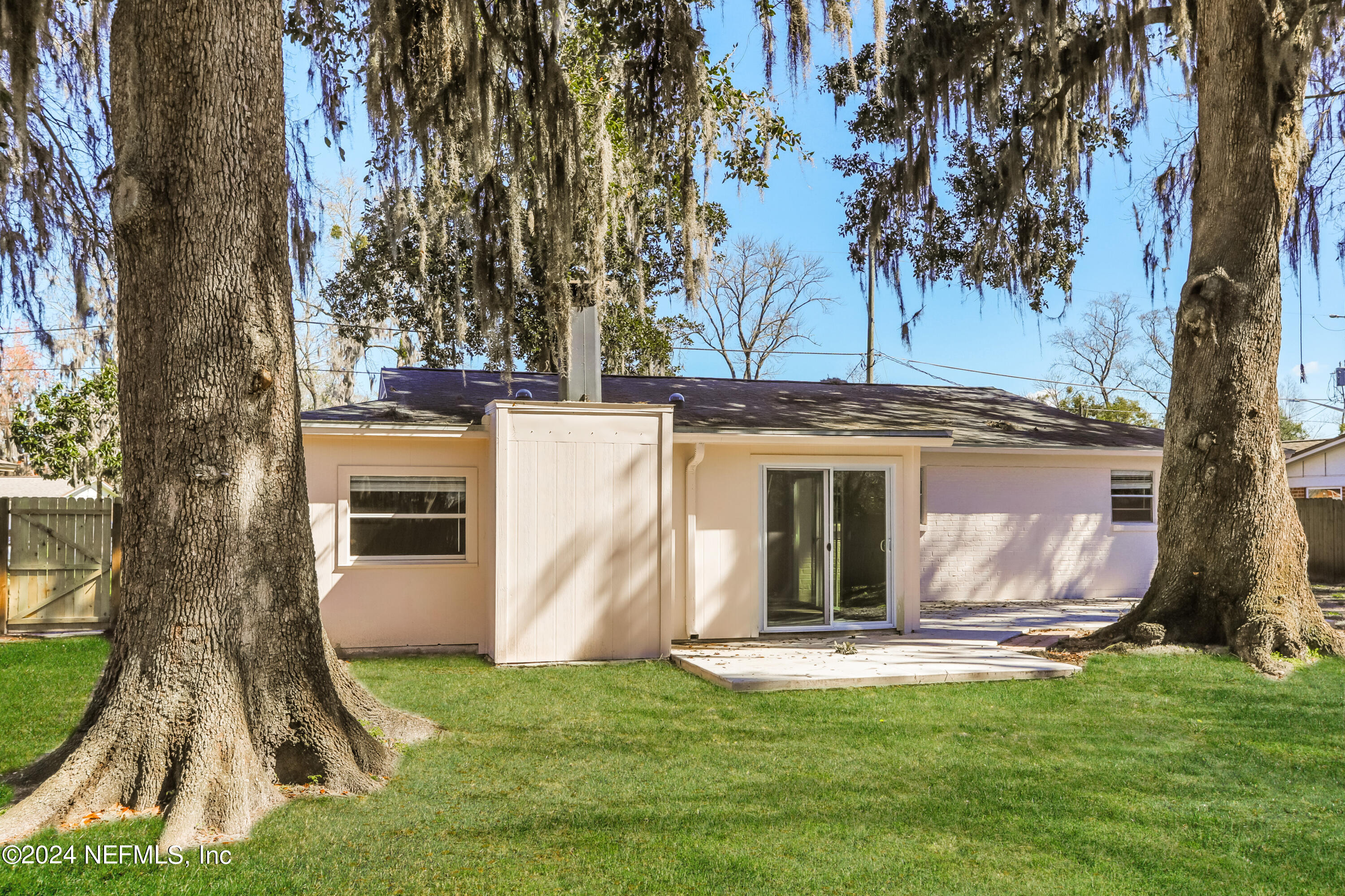 1220 Arbor Circle Orange Park, FL 32073 - Photo 14 of 15 a view of a white house with a big yard and large tree