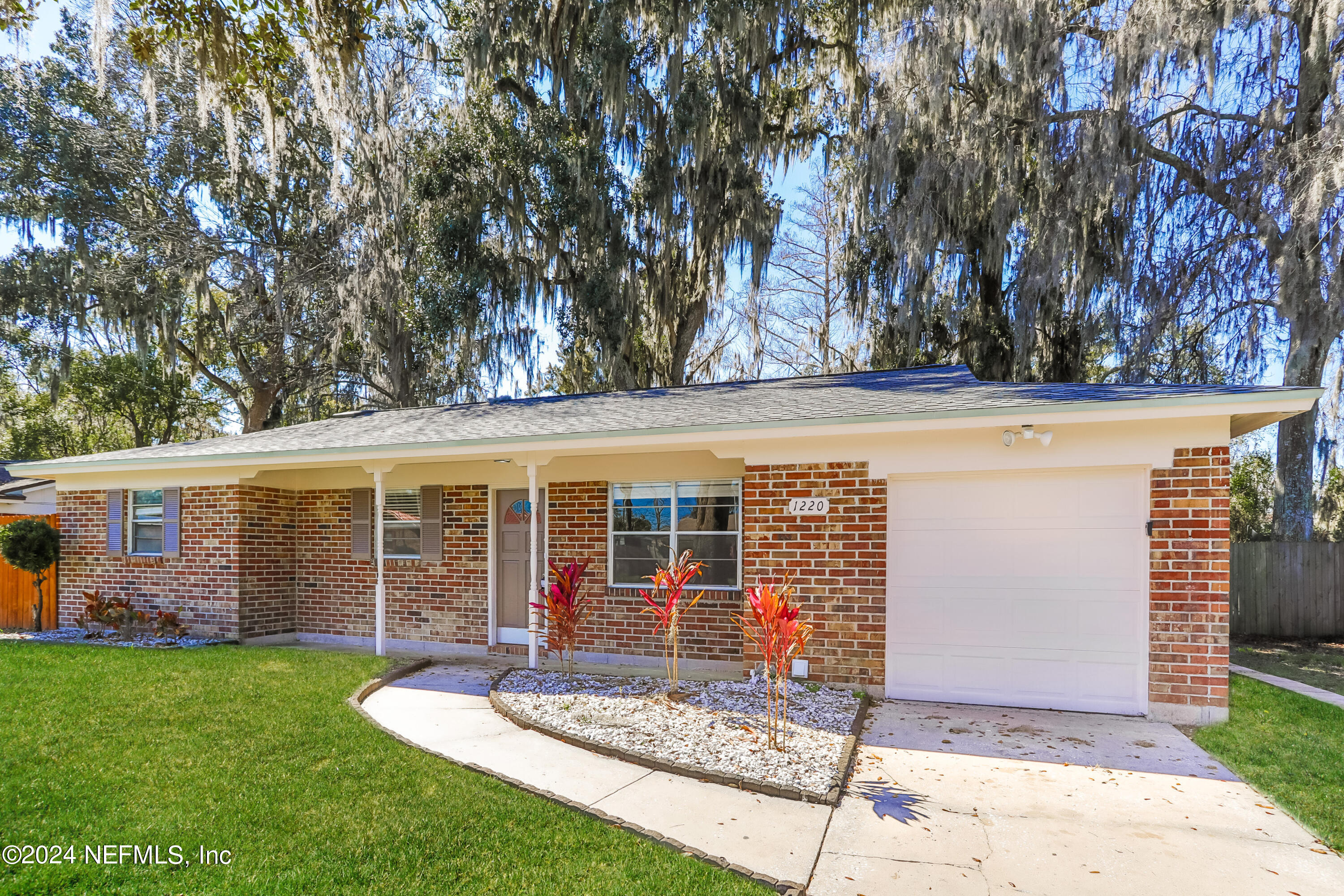 1220 Arbor Circle Orange Park, FL 32073 - Photo 2 of 15 front view of a house with a large tree