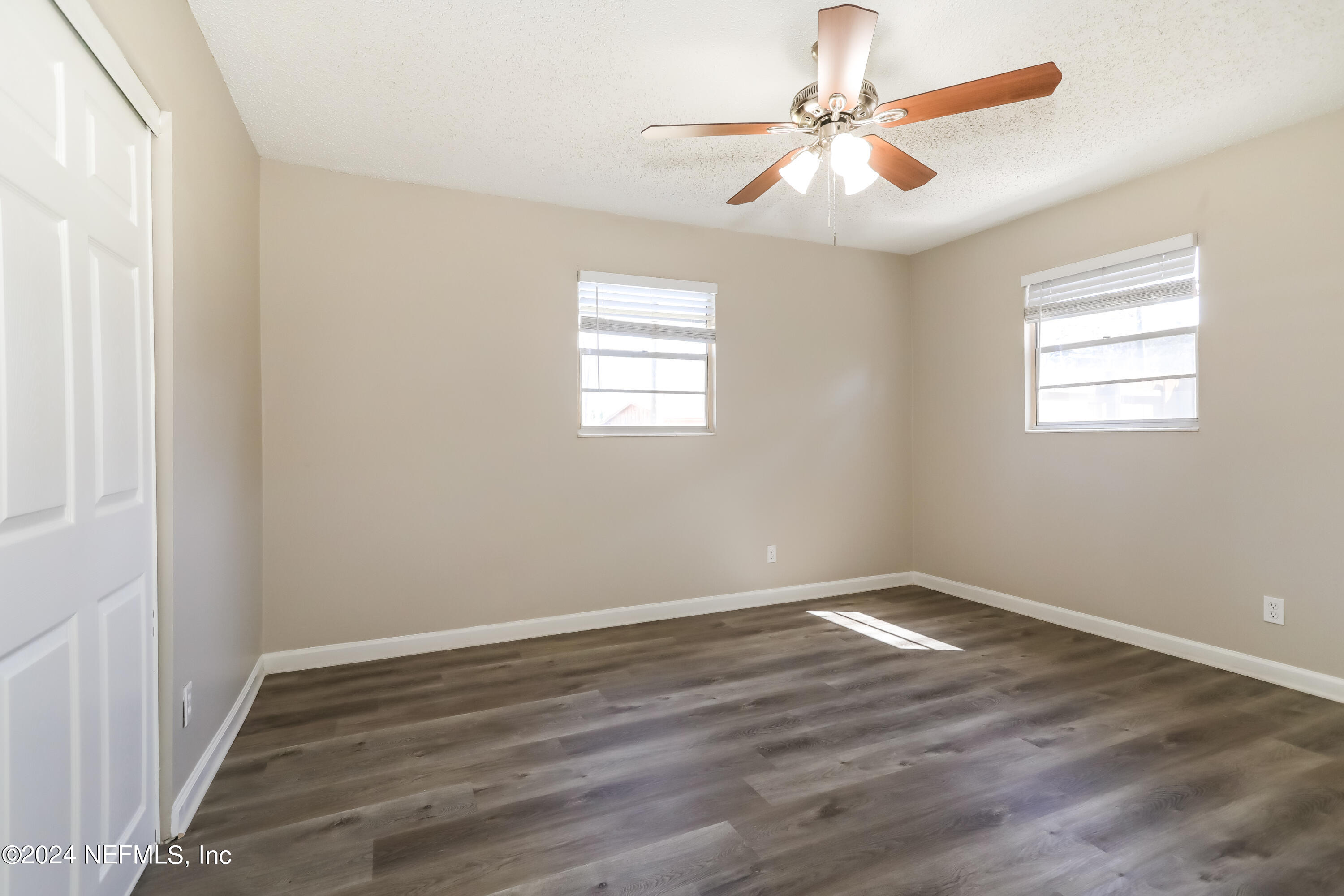 1220 Arbor Circle Orange Park, FL 32073 - Photo 8 of 15 wooden floor in an empty room with a window