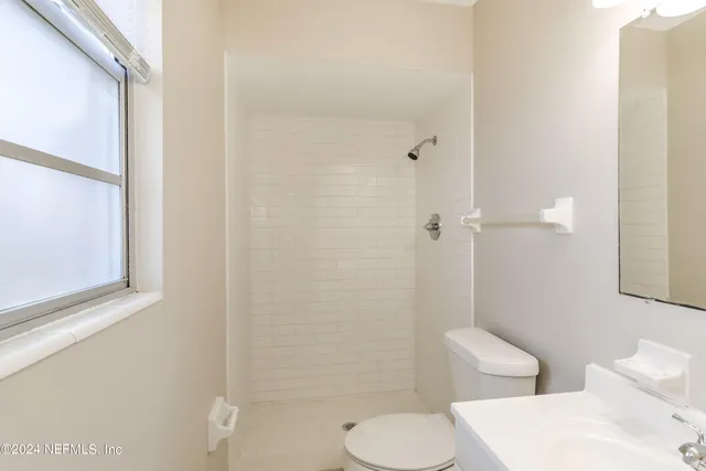 a bathroom with a toilet a sink and shower