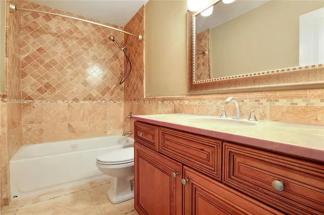 a bathroom with a sink a toilet and a bathtub