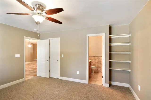 a view of an empty room with a ceiling fan