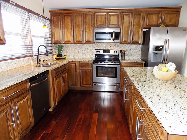 35 Timber Hill Road Buffalo Grove, IL 60089 - Photo 3 of 18 a kitchen with stainless steel appliances kitchen island granite countertop a sink stove refrigerator granite counter tops wooden cabinets and wooden floor