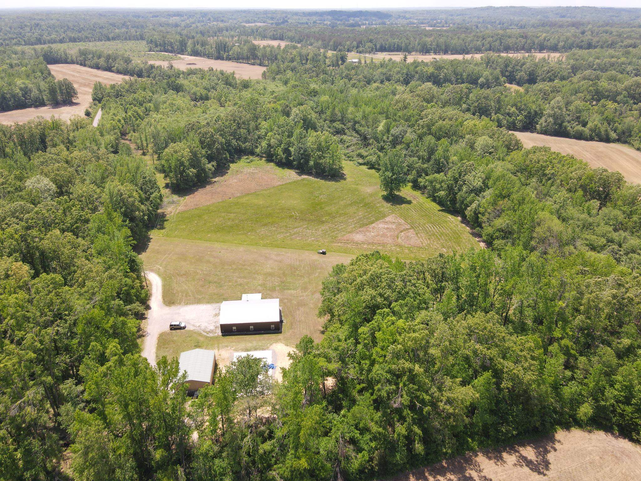 an aerial view of a house with a yard