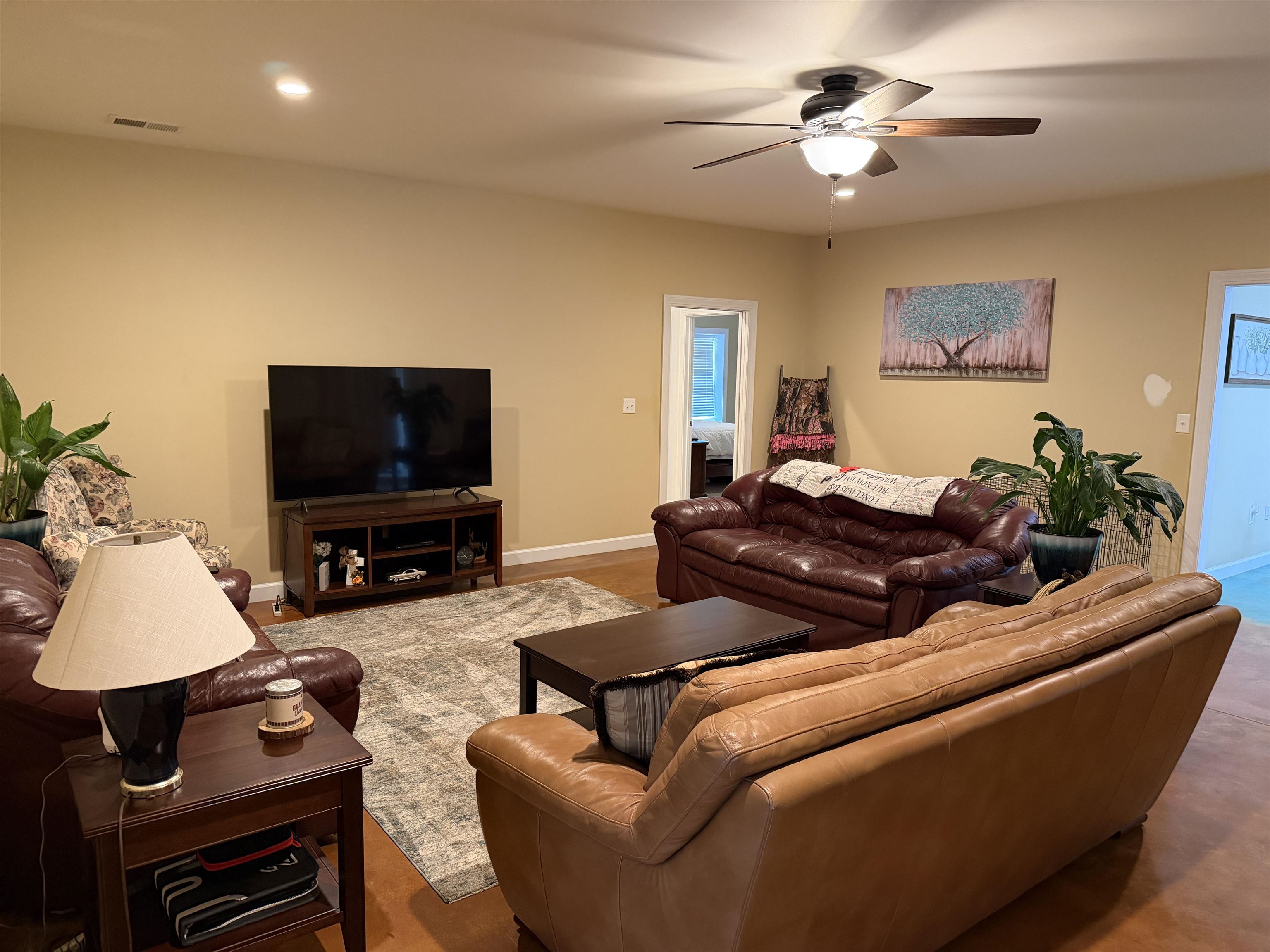 710 Harlon Iron Road Morris Chapel, TN 38361 - Photo 11 of 40 a living room with furniture a flat screen tv and a lamp