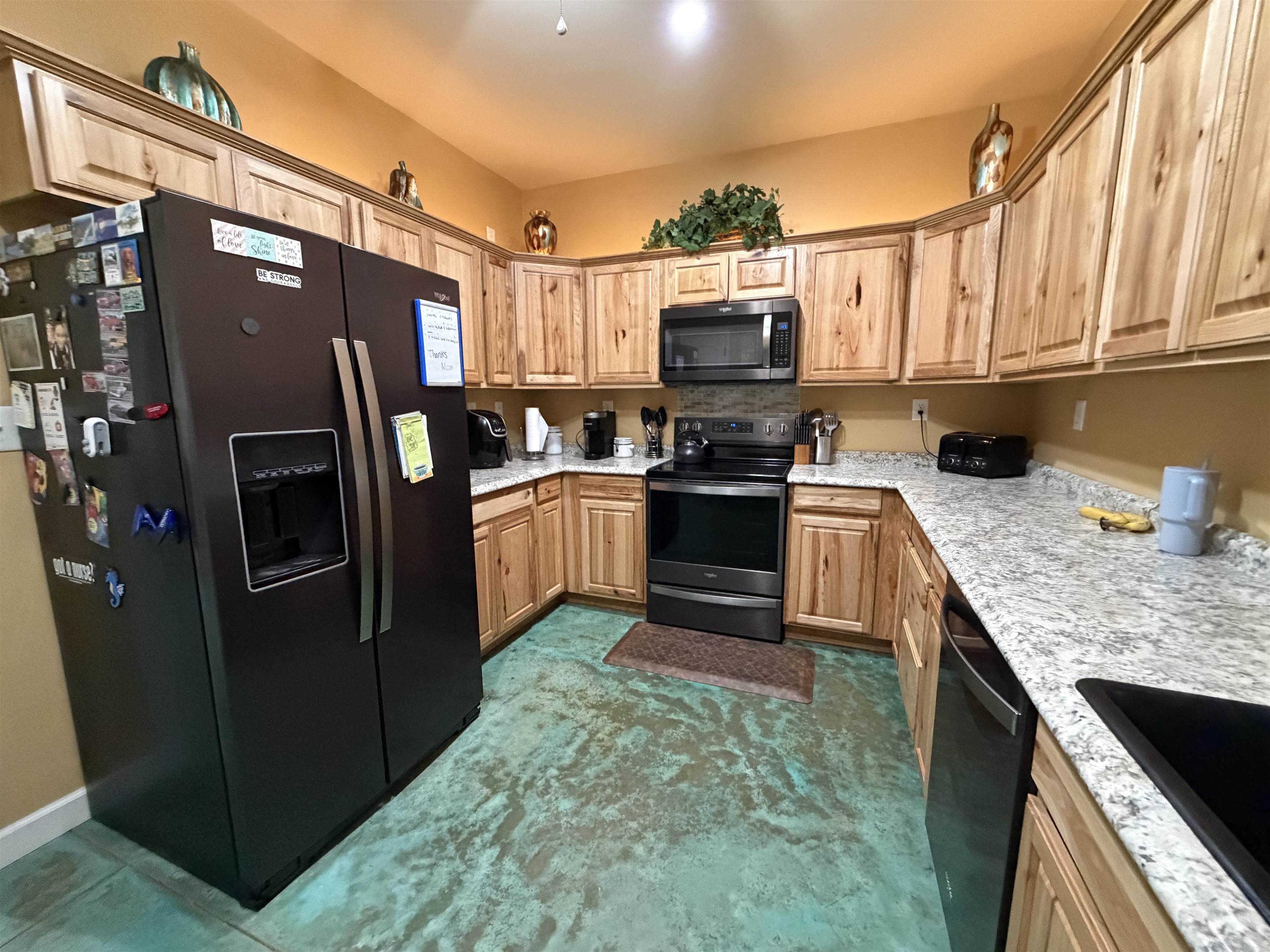 710 Harlon Iron Road Morris Chapel, TN 38361 - Photo 14 of 40 a kitchen with stainless steel appliances granite countertop a stove a refrigerator and a sink