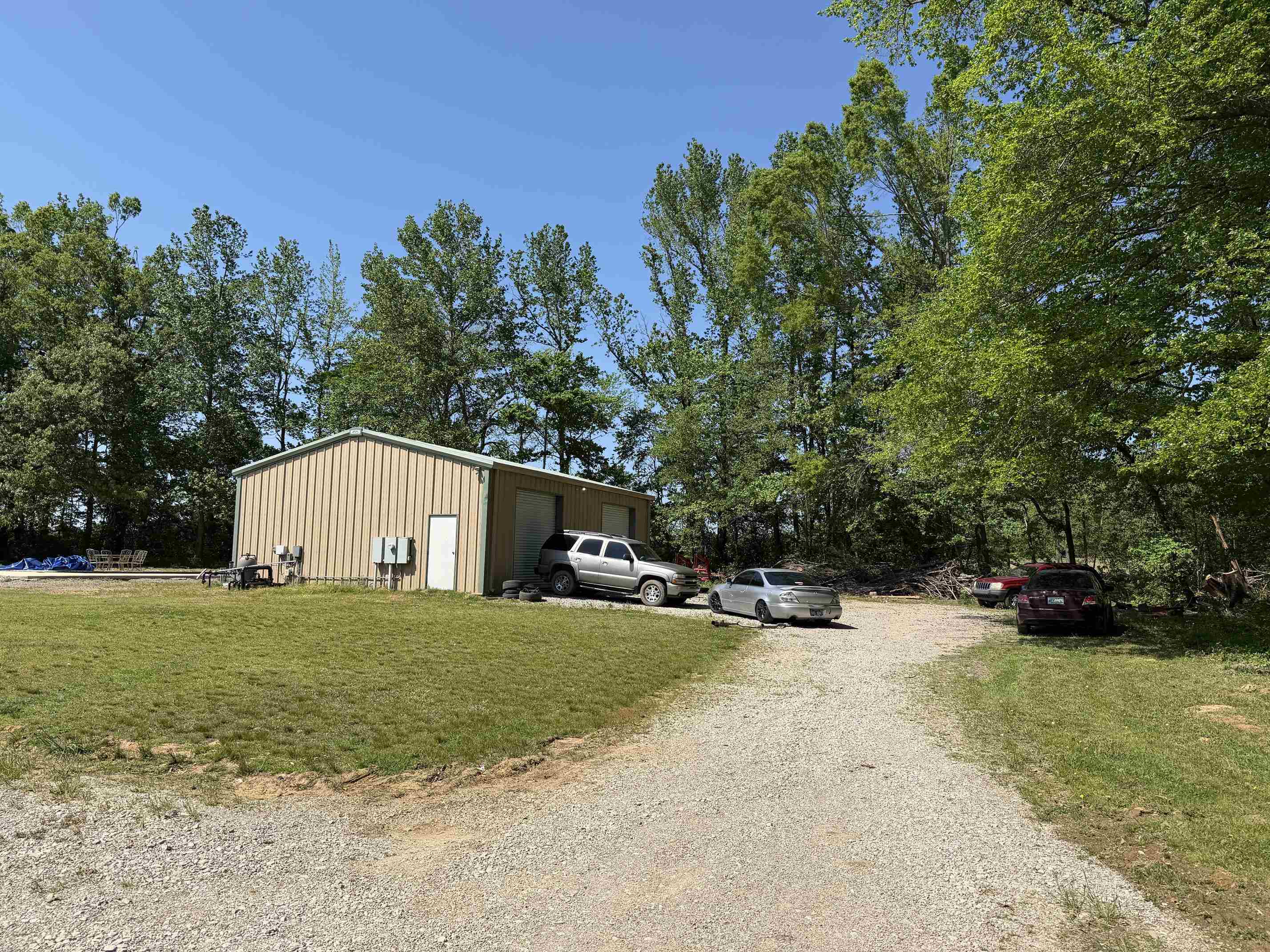 710 Harlon Iron Road Morris Chapel, TN 38361 - Photo 29 of 40 a view of a house with a yard and garage