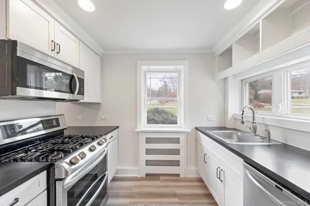 a kitchen with stainless steel appliances a stove and a sink
