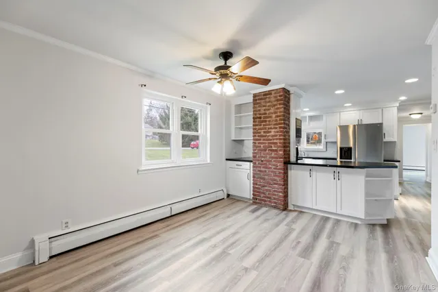 a view of a kitchen with a stove cabinets and a wooden floor