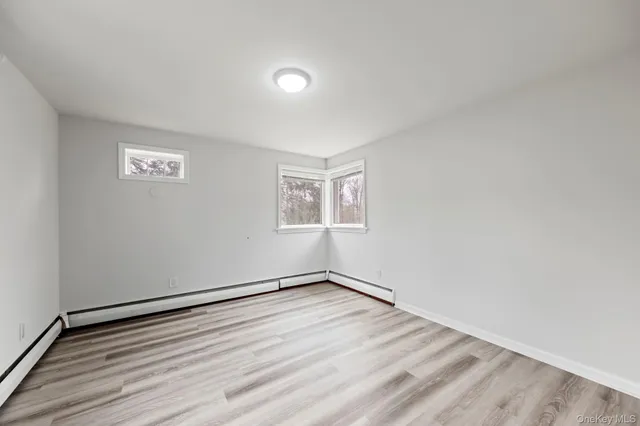 a view of a room with wooden floor and window