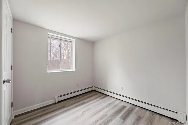 a view of an empty room and wooden floor