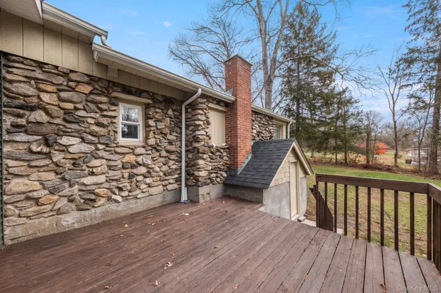 a view of a house with a garden and deck