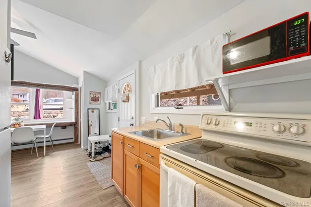 a kitchen with a sink refrigerator and microwave