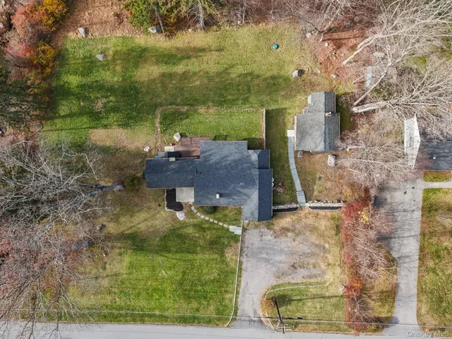 a front view of house with yard seating and green space
