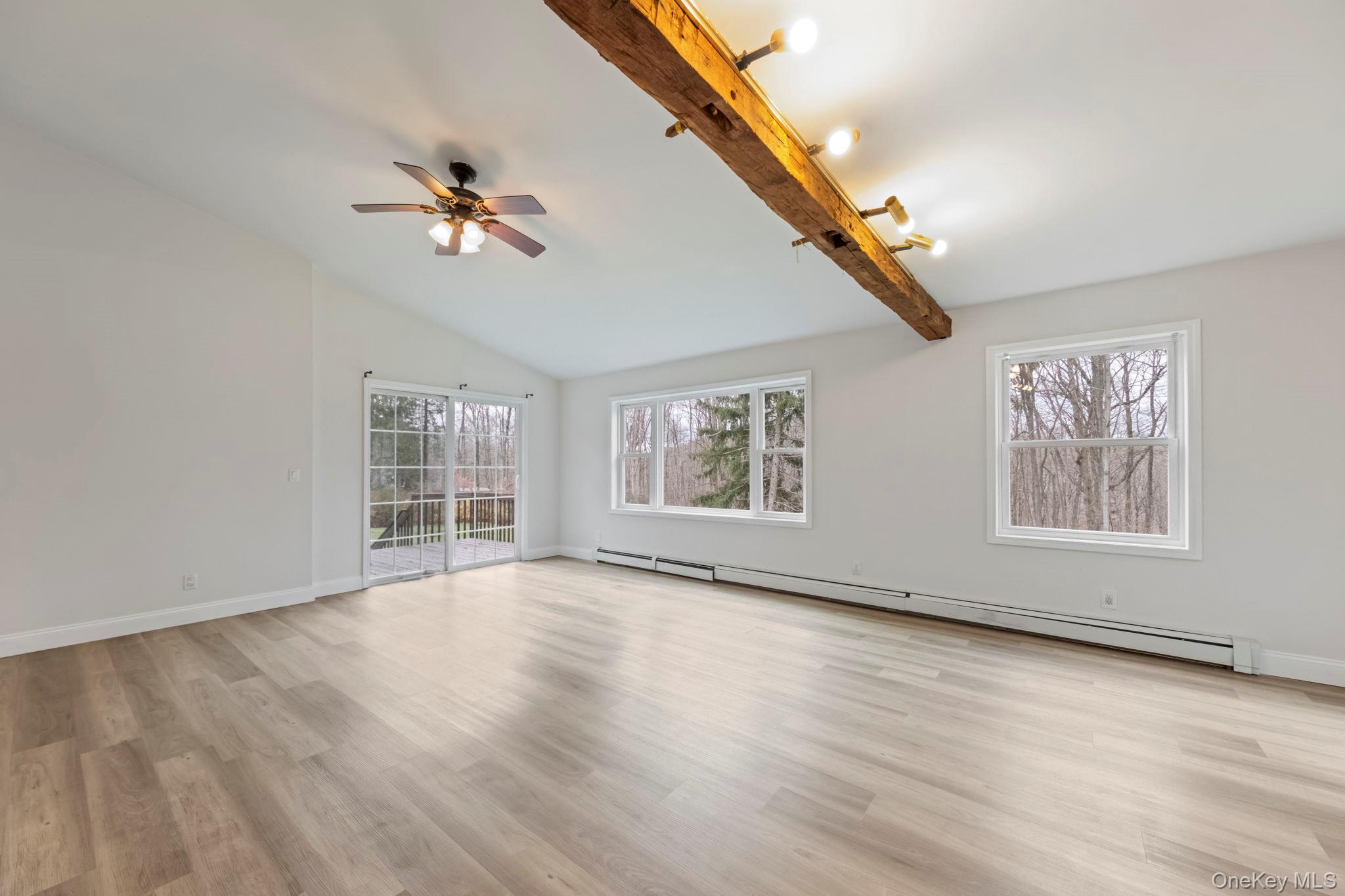 18 Lakeview Road Carmel, NY 10512 - Photo 6 of 44 a view of an empty room with a window and wooden floor
