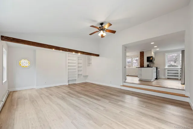 a kitchen with stainless steel appliances a stove microwave and sink