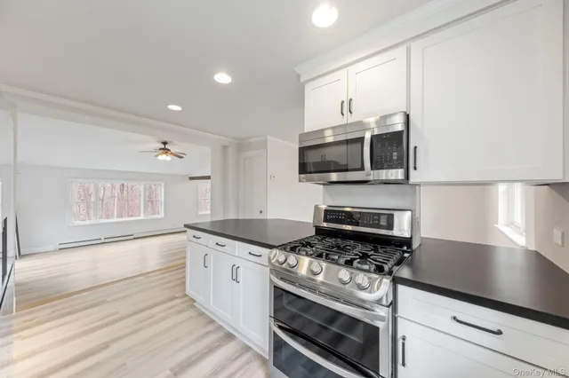 a kitchen with stainless steel appliances granite countertop a refrigerator and a sink