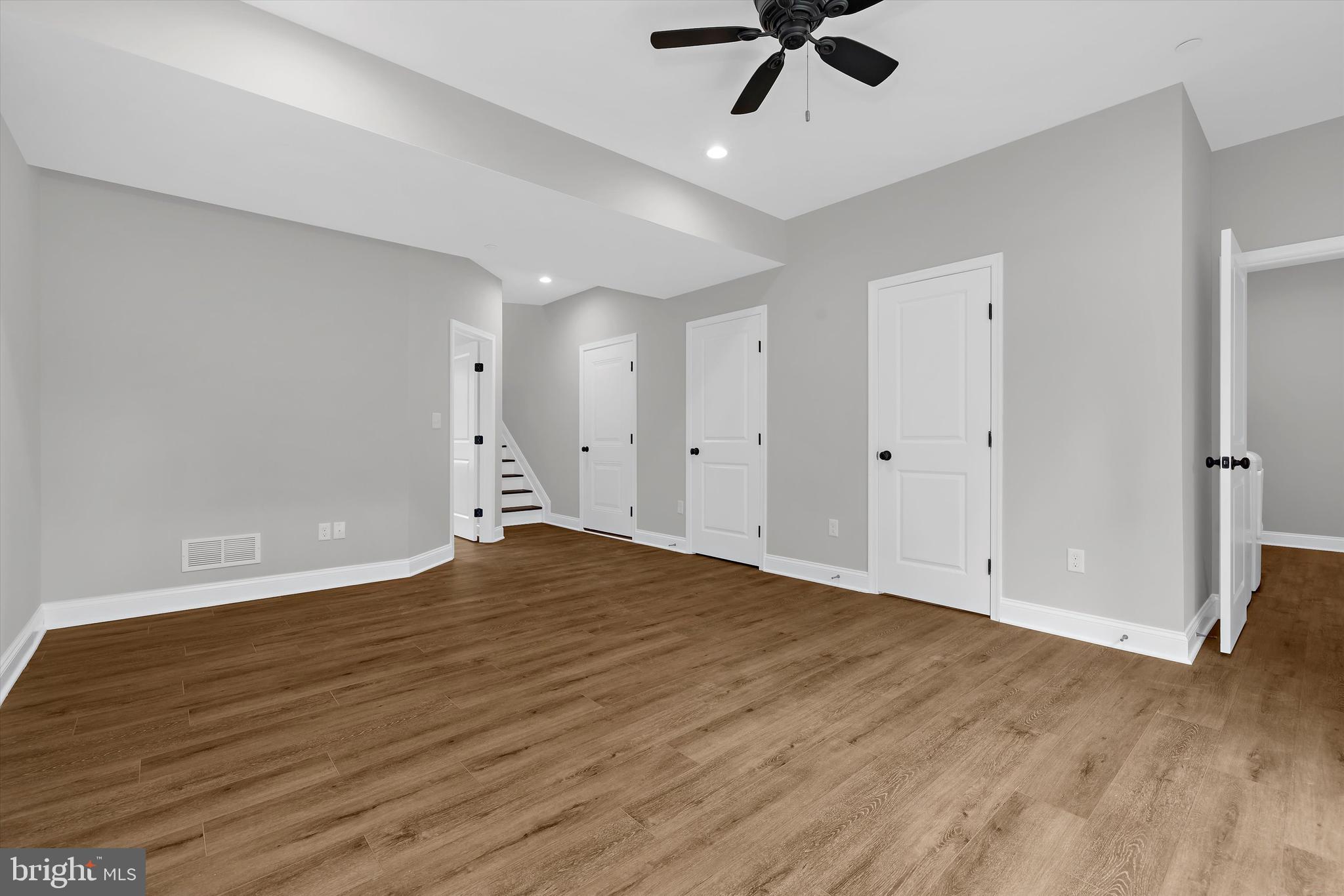 211 Greenland Beach Road Greenland Beach, MD 21226 - Photo 20 of 48 a view of empty room with wooden floor and ceiling fan