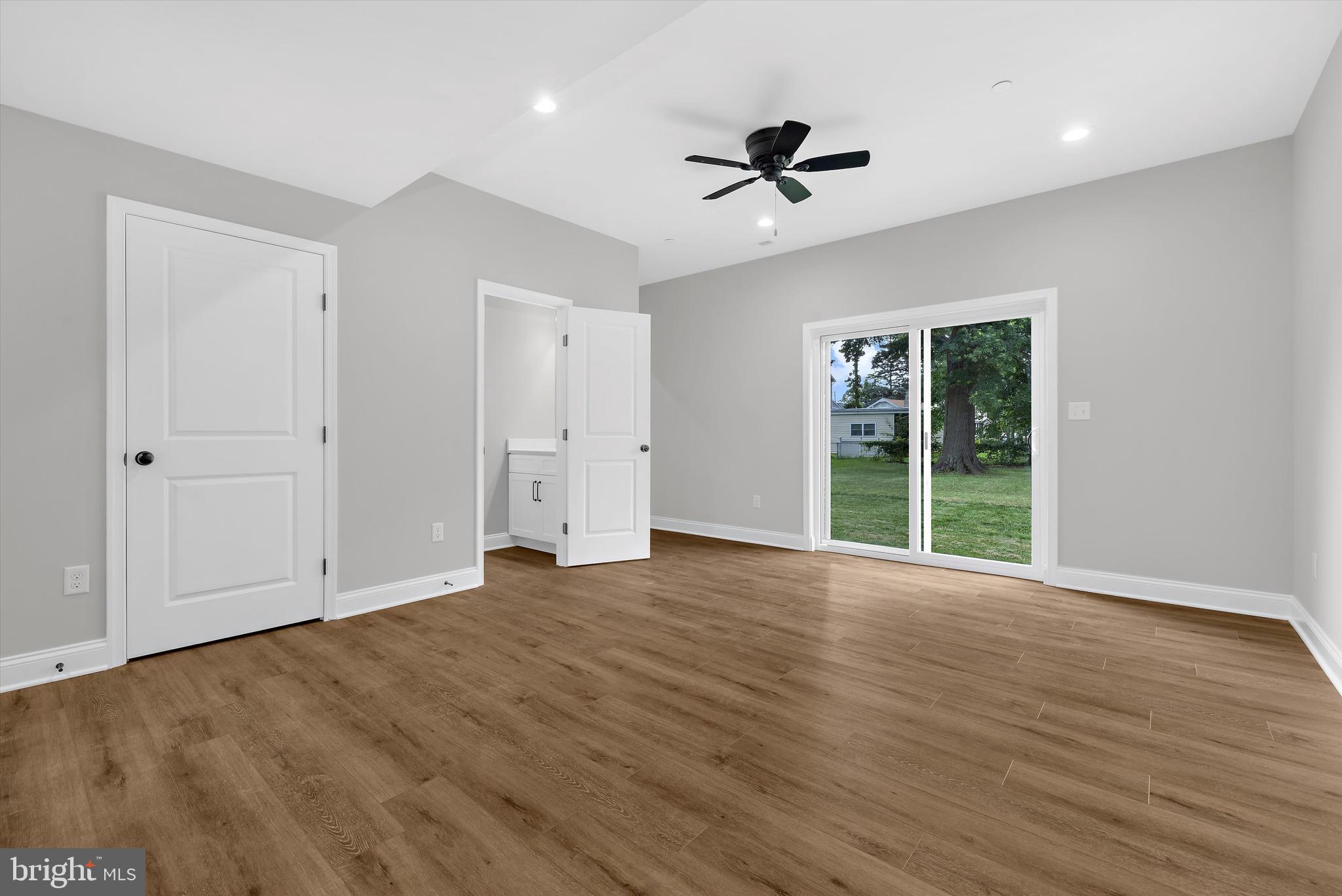 211 Greenland Beach Road Greenland Beach, MD 21226 - Photo 21 of 48 a view of an empty room with a window and wooden floor