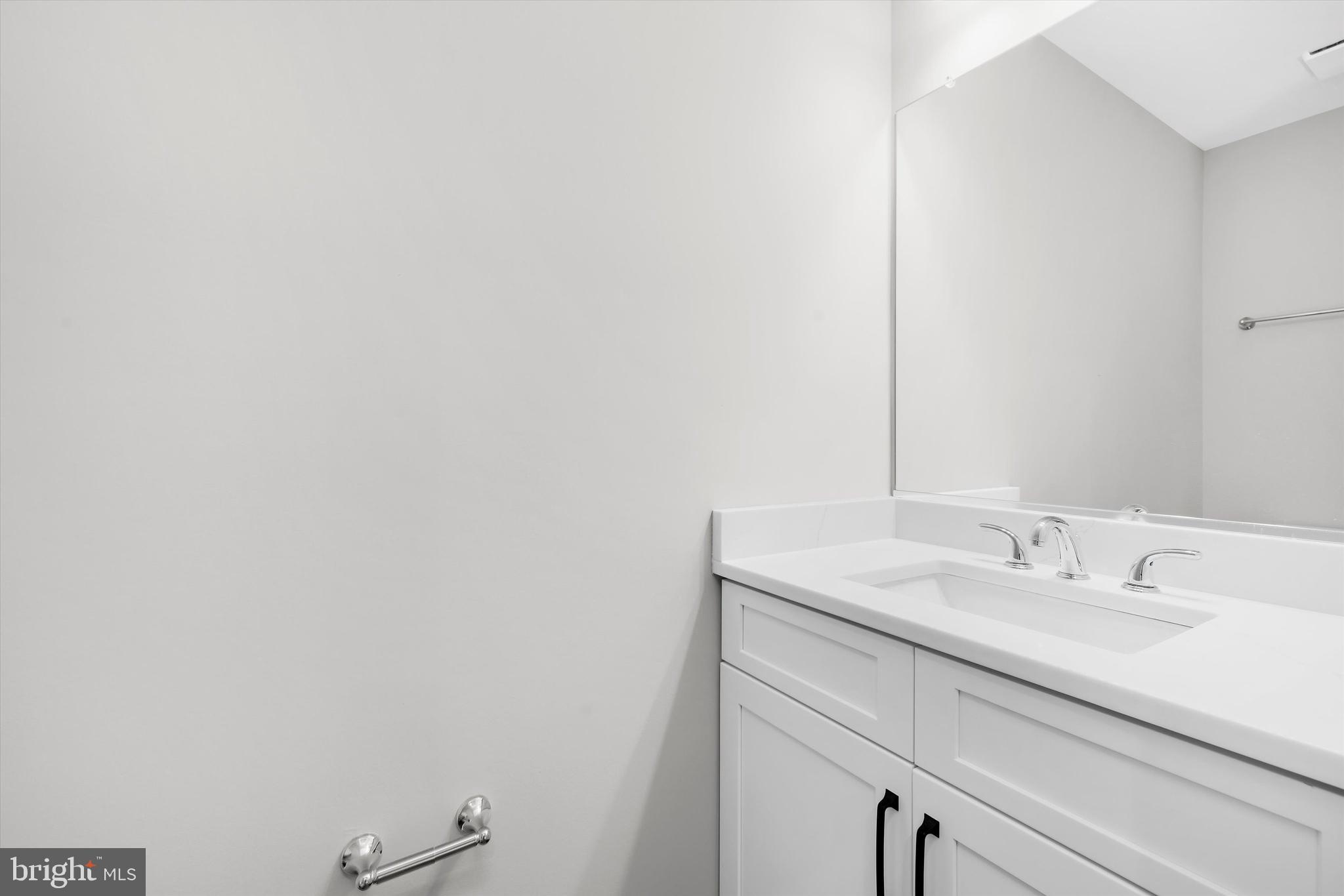 211 Greenland Beach Road Greenland Beach, MD 21226 - Photo 24 of 48 a bathroom with a sink and a mirror