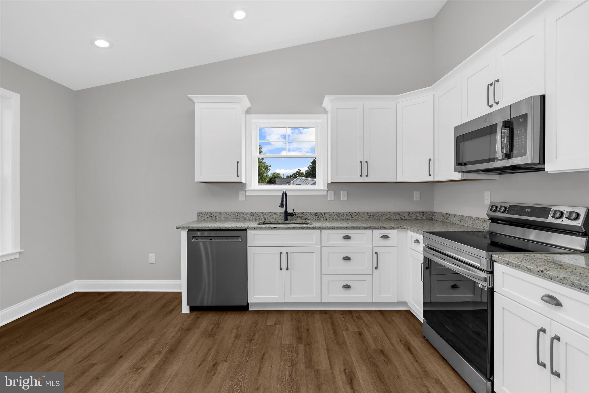 211 Greenland Beach Road Greenland Beach, MD 21226 - Photo 3 of 48 a kitchen with stainless steel appliances granite countertop a stove a sink and a microwave
