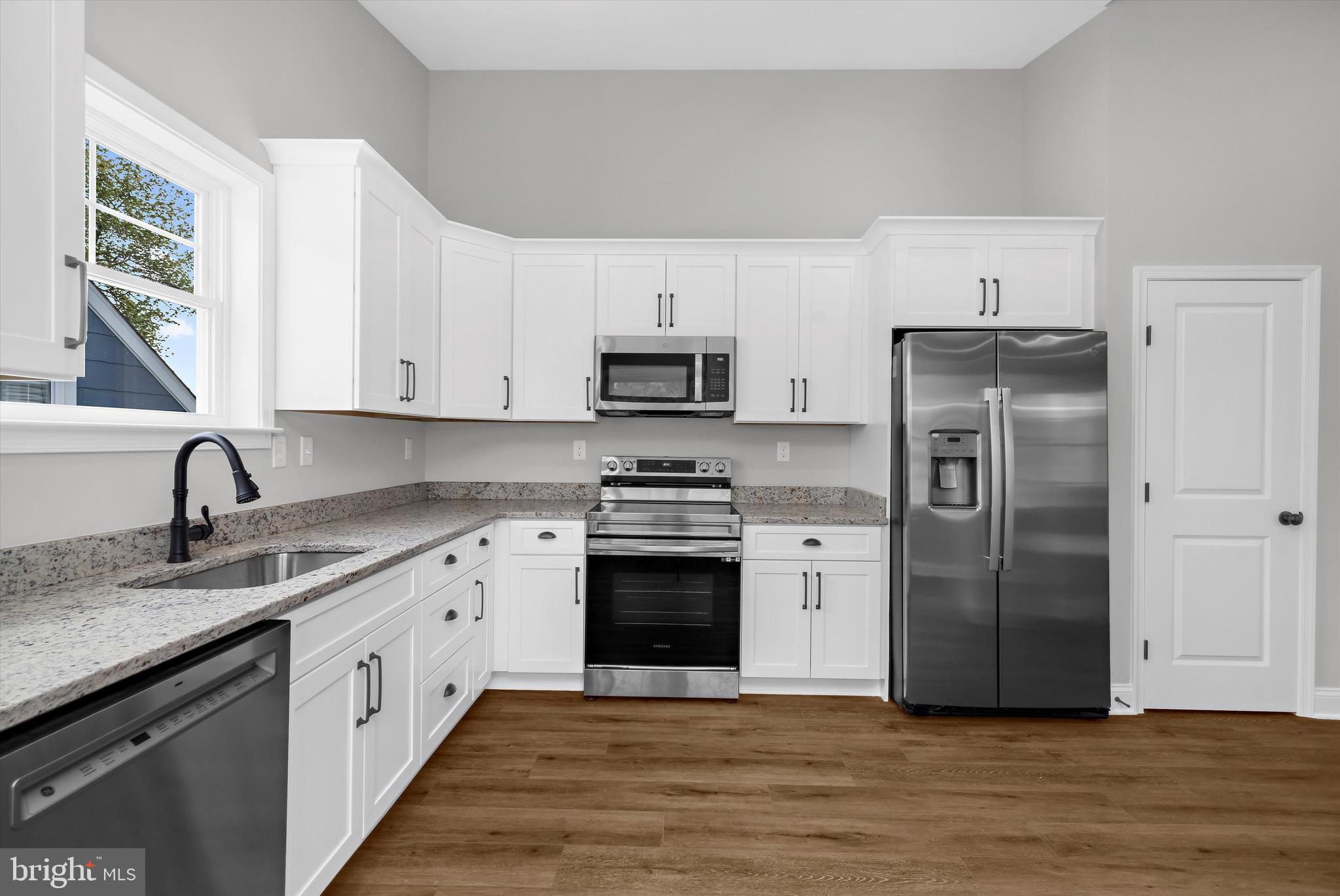 211 Greenland Beach Road Greenland Beach, MD 21226 - Photo 4 of 48 a kitchen with a stove top oven a sink and a refrigerator