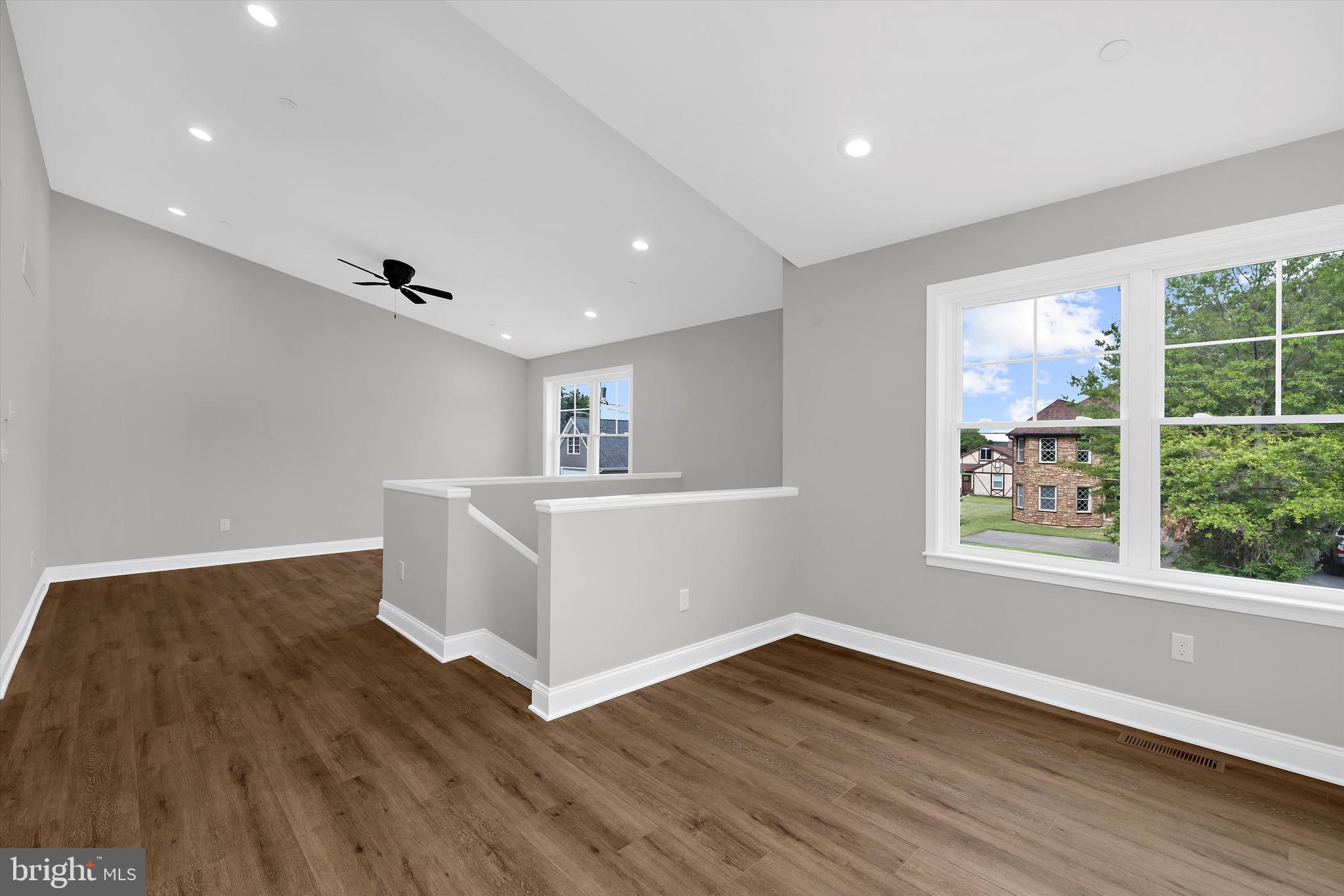 211 Greenland Beach Road Greenland Beach, MD 21226 - Photo 6 of 48 a view of an empty room with wooden floor and a window