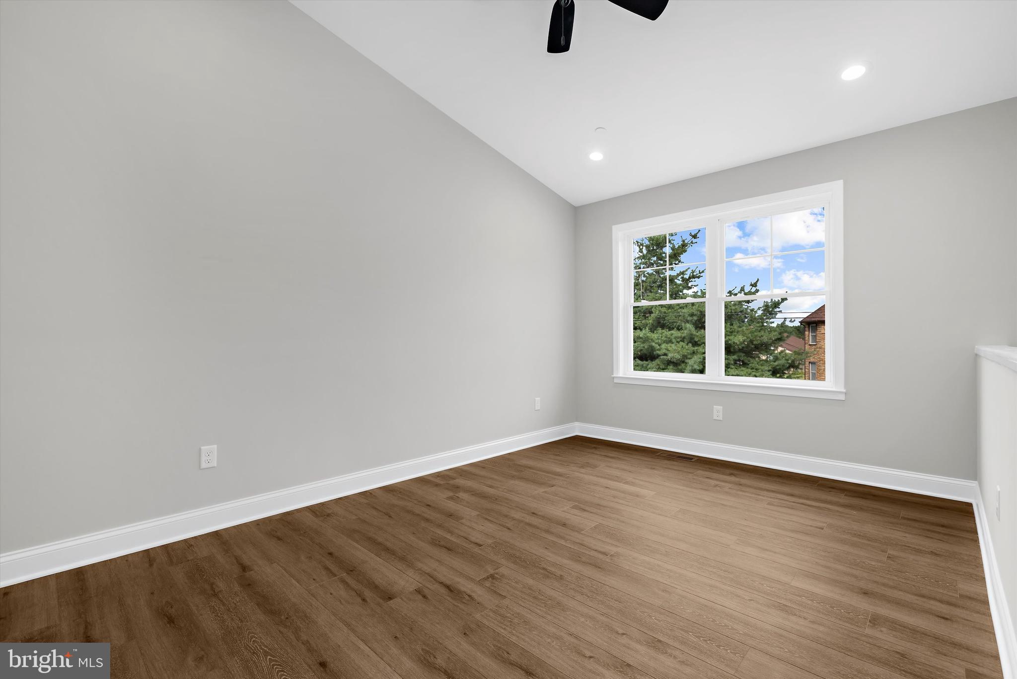 211 Greenland Beach Road Greenland Beach, MD 21226 - Photo 7 of 48 a view of an empty room with wooden floor and a window