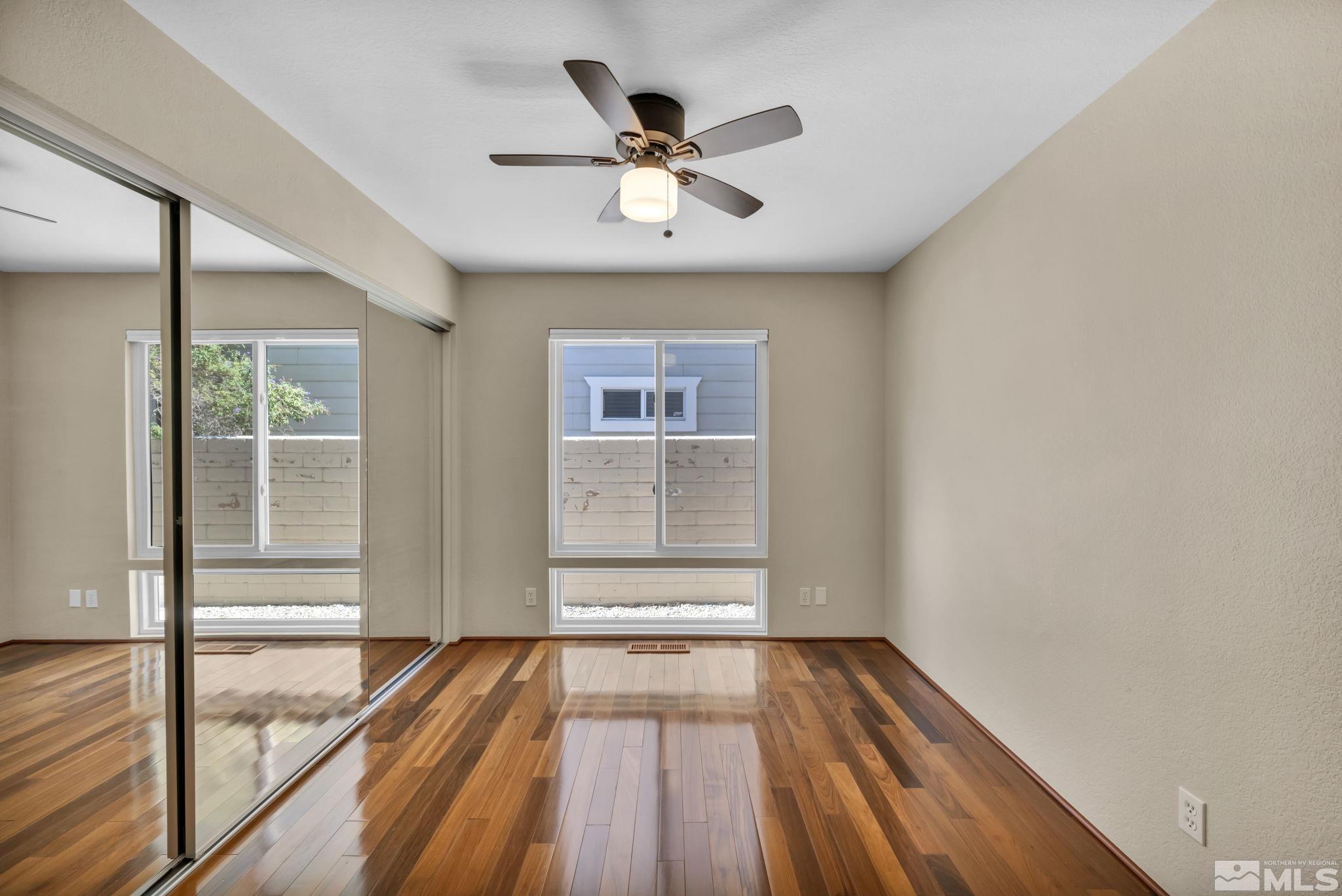 7109 Lighthouse Lane Reno, NV 89511 - Photo 21 of 40 a view of empty room with wooden floor and fan